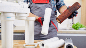Worker replacing water filter parts 